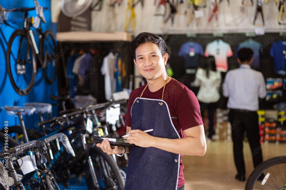 Bicycle salesman He is checking order in stock.