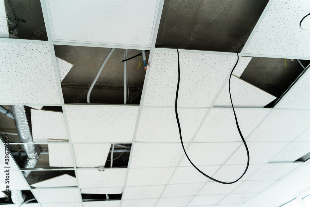 Empty places on celing before plasterboards assembling. Cables for lamps hanging from the celing.