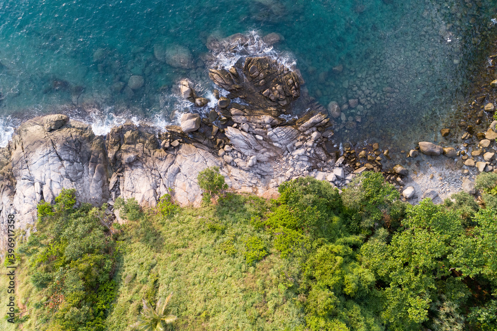 High angle view Tropical sea with wave crashing on seashore and high mountain located in Phuket Thai