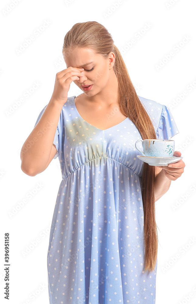 Troubled young woman with coffee stains on her dress on white background