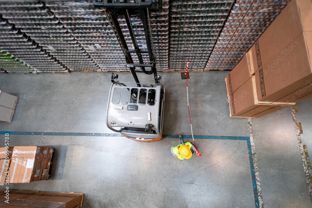 Forklift in warehouse at work, above view