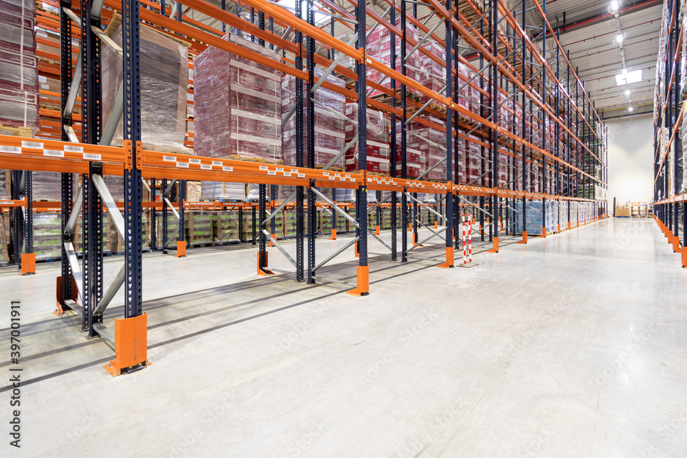 Tall racks alley in huge storage warehouse