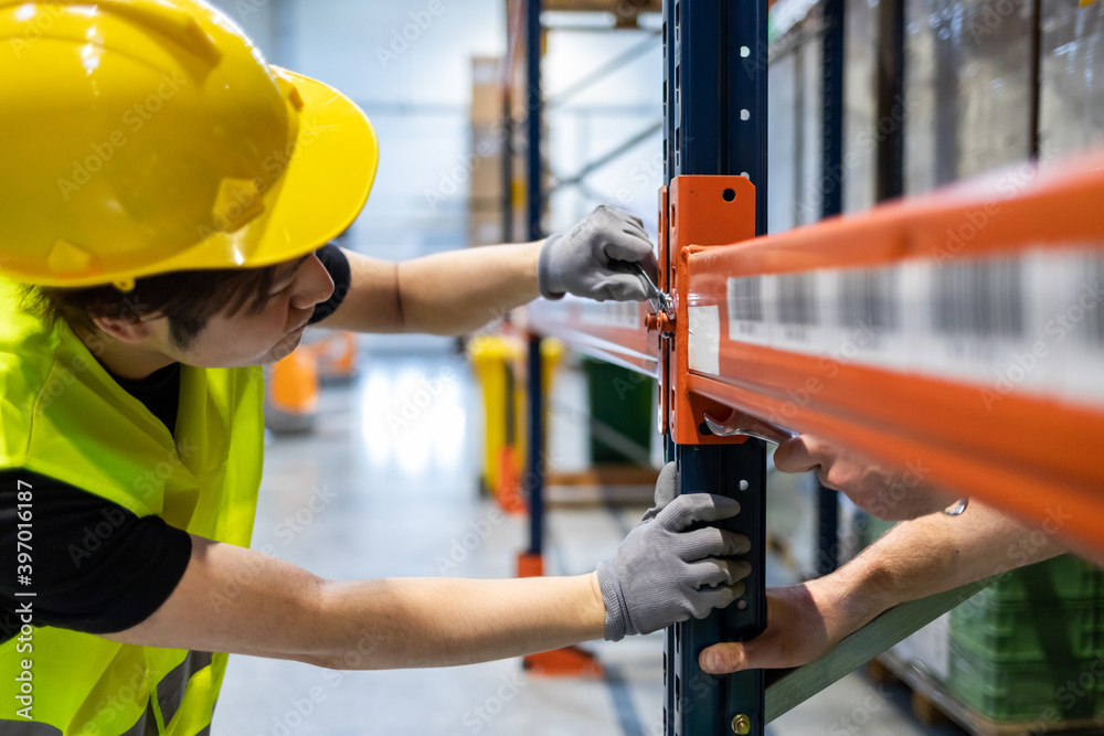 Worker during rack arrangement erection work in warehouse