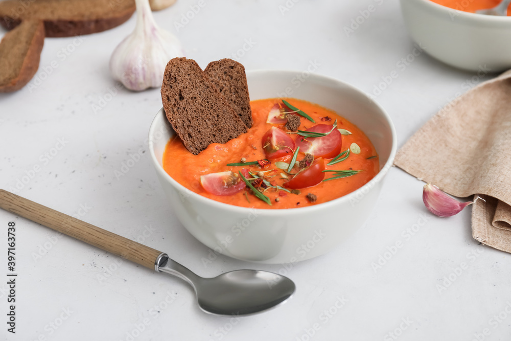 Bowl of tasty tomato cream soup on table