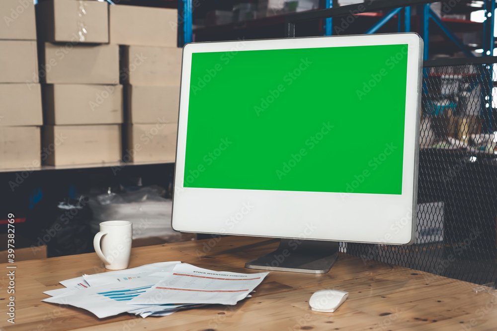 Computer with green screen display in warehouse storage room . Delivery and transportation software 