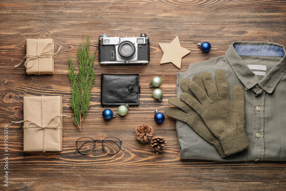 Christmas composition with stylish clothes and accessories on wooden background