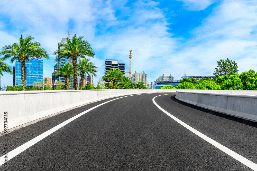 Empty asphalt road and Shanghai skyline with buildings scenery.