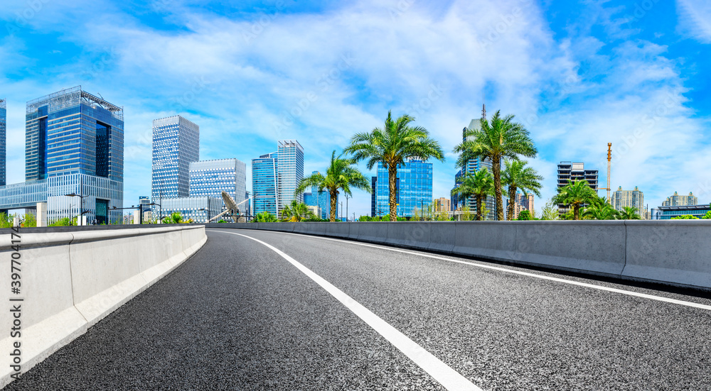 Empty asphalt road and Shanghai skyline with buildings scenery.