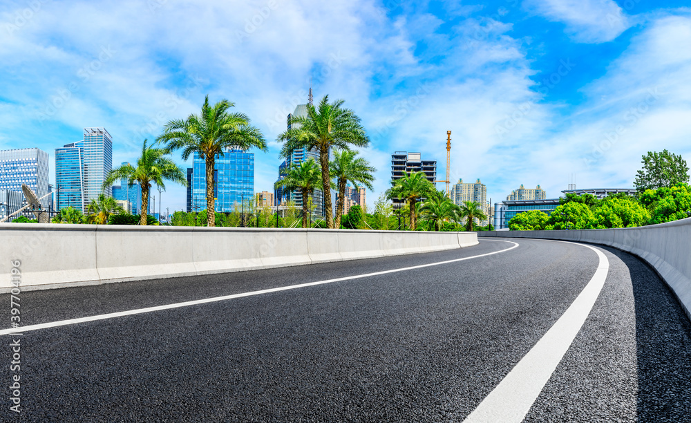 Empty asphalt road and Shanghai skyline with buildings scenery.