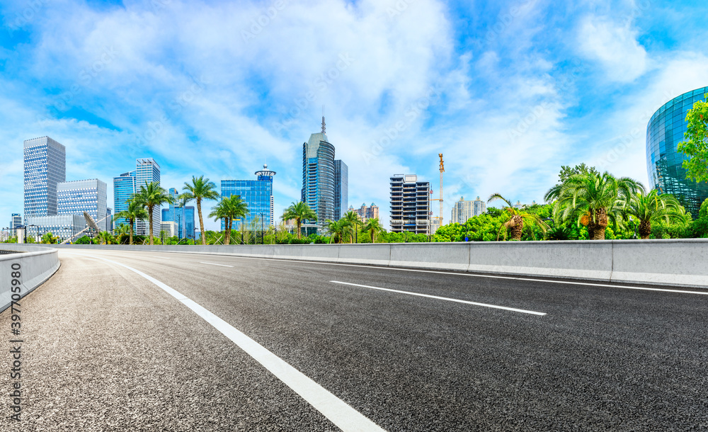 Empty asphalt road and Shanghai skyline with buildings scenery.