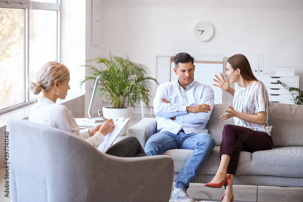 Psychologist working with young couple in office