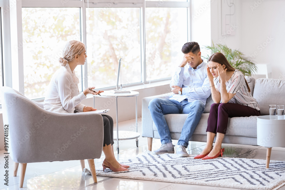 Psychologist working with young couple in office