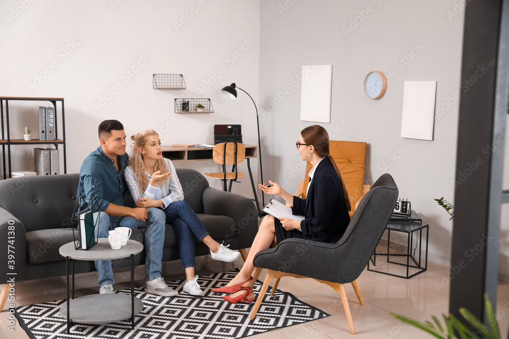 Psychologist working with young couple in office