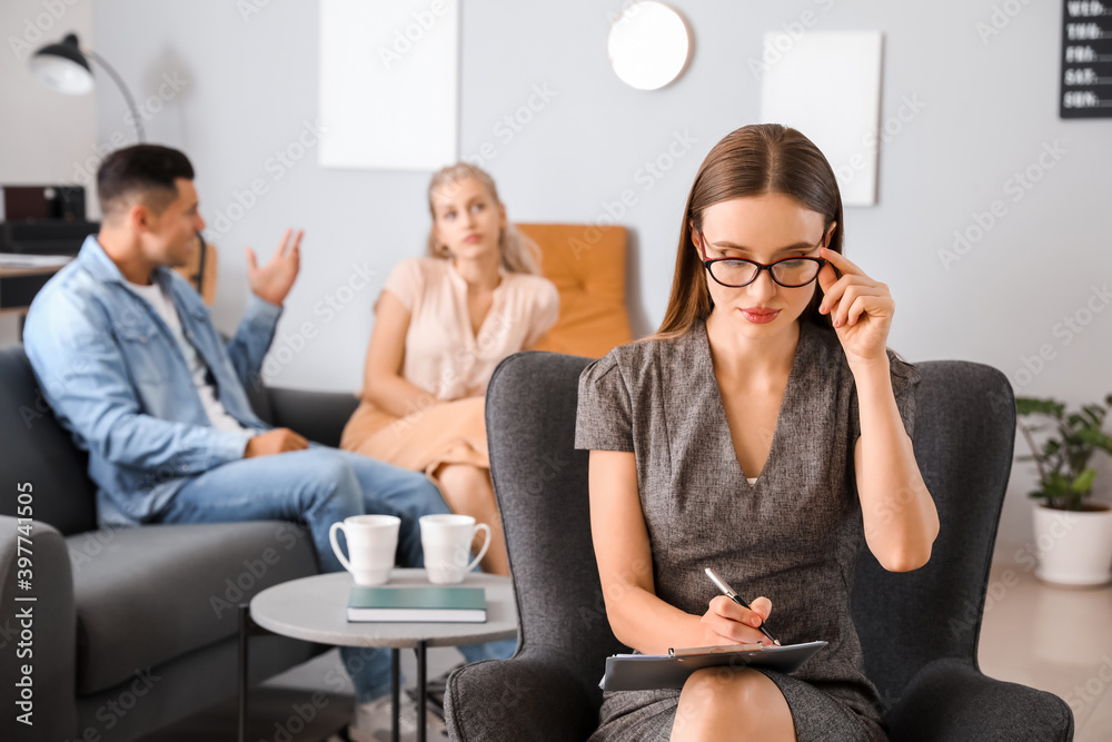 Psychologist working with young couple in office