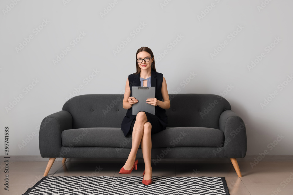 Portrait of female psychologist sitting on sofa in office