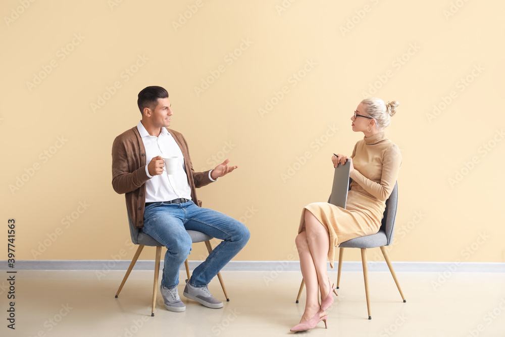 Psychologist working with young man in office