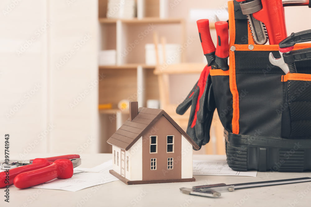 Model of new house with supplies on table