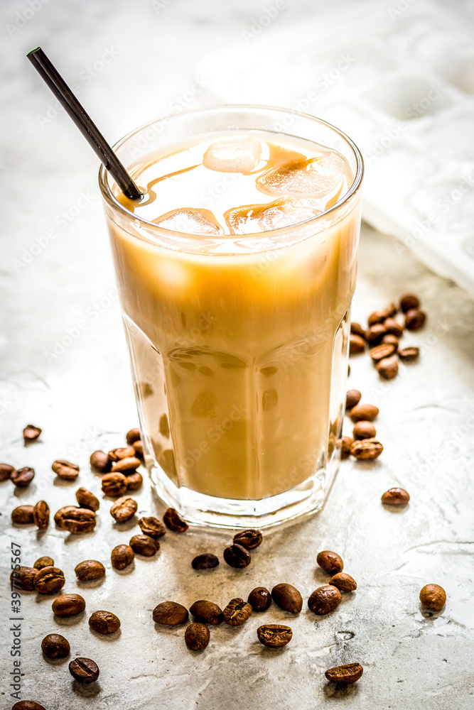 iced coffee with beans for cold summer drink on stone background