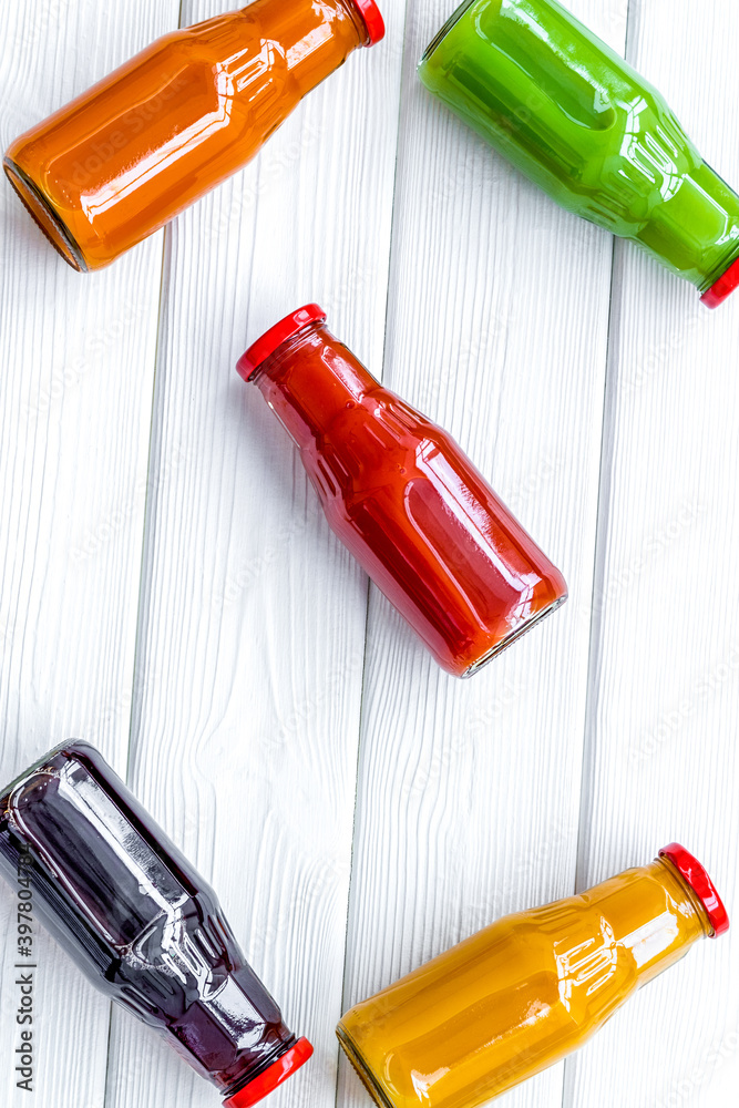 fresh organic juices in bottles for fitness diet on white wooden background top view mock-up