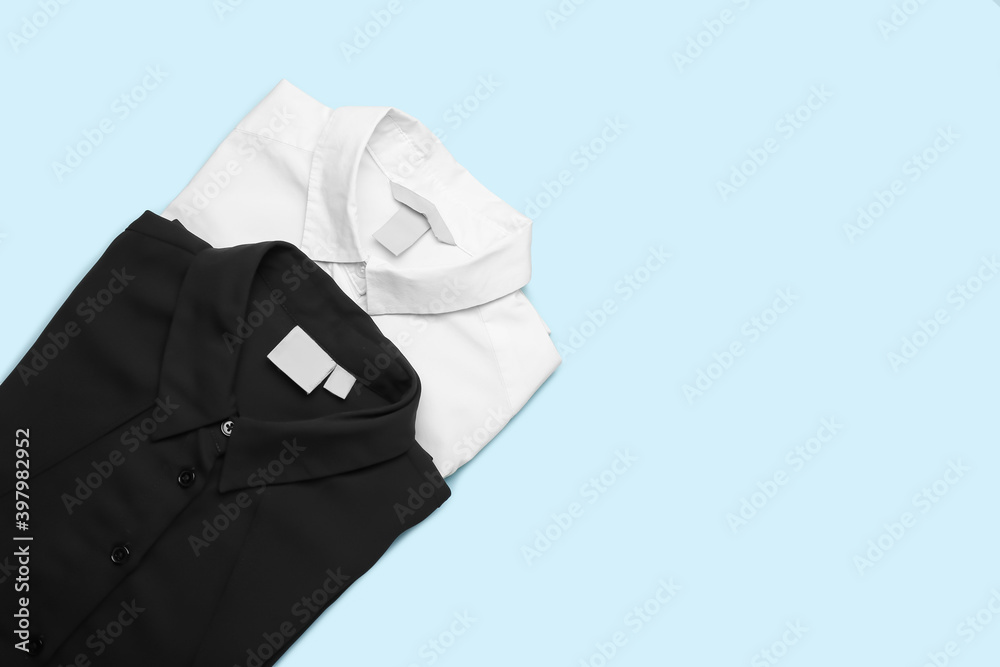 Stylish male shirts on color background