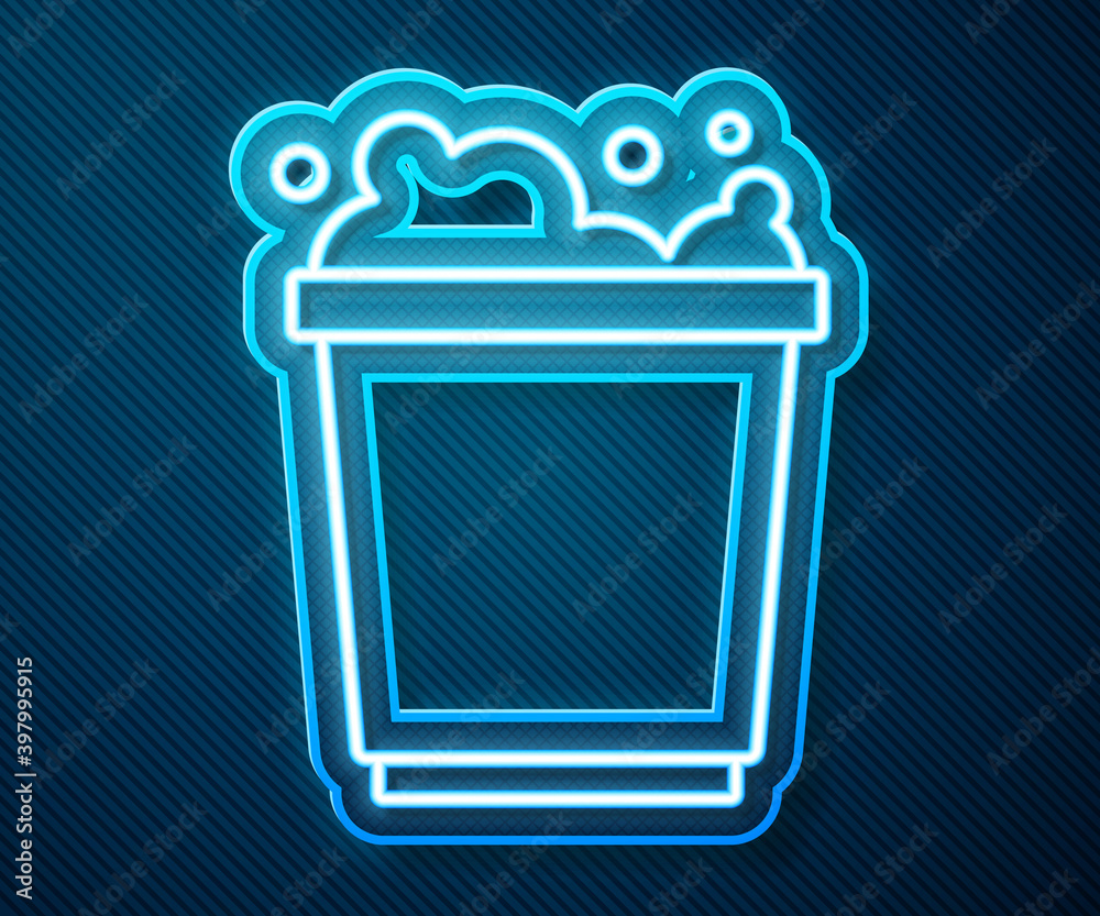 Glowing neon line Bucket with foam and bubbles icon isolated on blue background. Cleaning service co