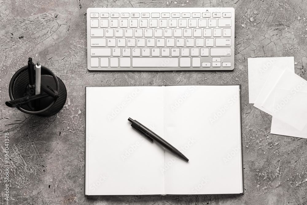 Notebook with pen on dark background