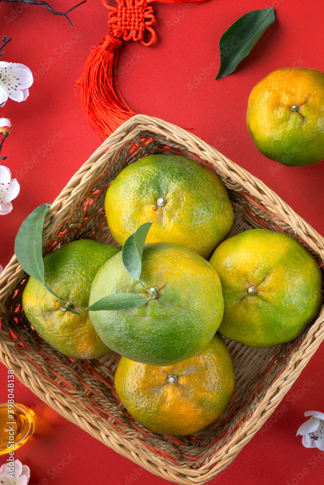 Top view of fresh tangerine mandarin orange on red background for Chinese lunar new year.