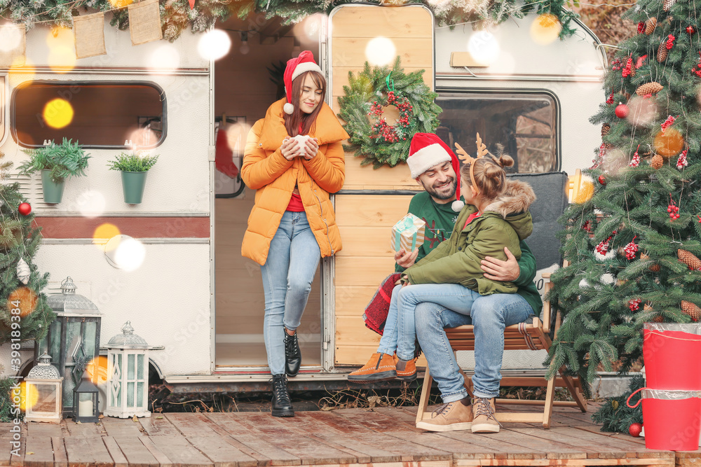 Happy family celebrating Christmas outdoors