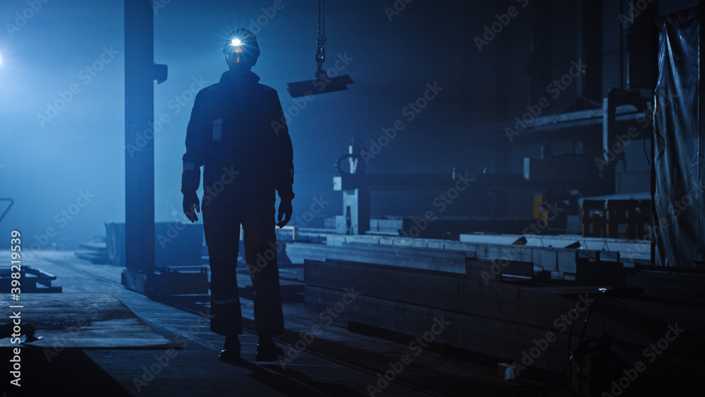 Professional Heavy Industry Engineer/Worker Wearing Uniform, Flashlight on the Hard Hat in a Steel F