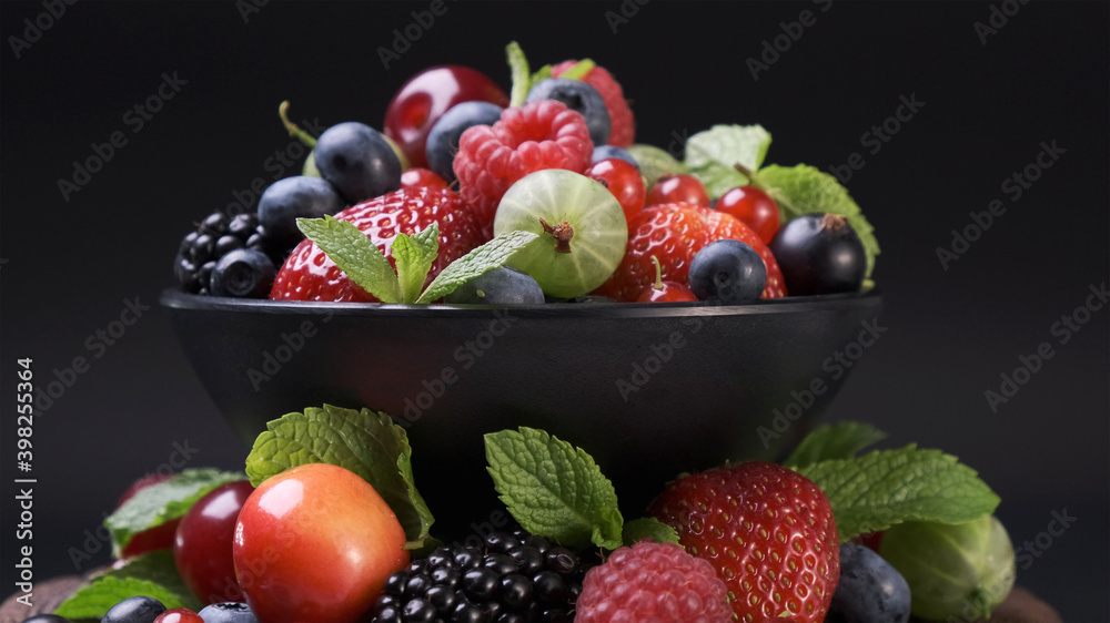 Mix of wild berries on black background