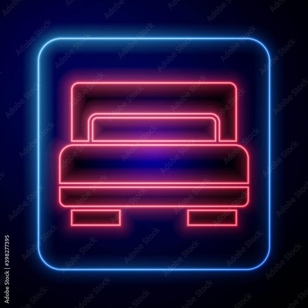 Glowing neon Hotel room bed icon isolated on blue background. Vector.