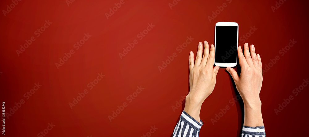 Person using a white smartphone from above