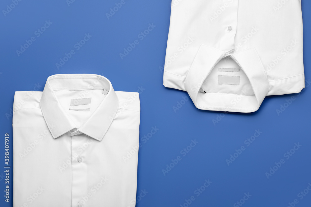 New male shirts on color background