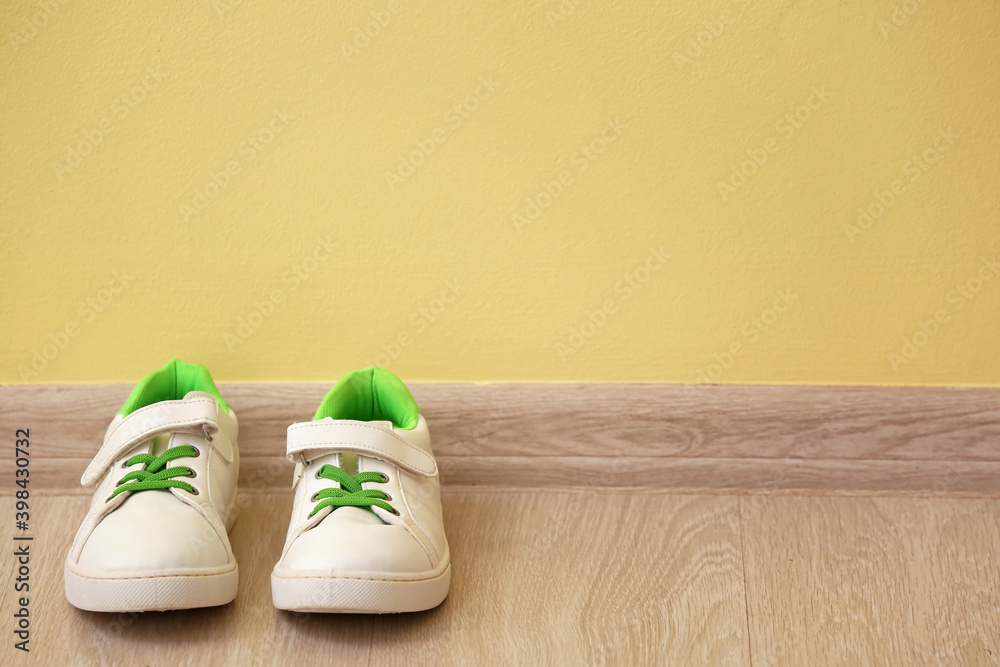 Childs shoes near color wall