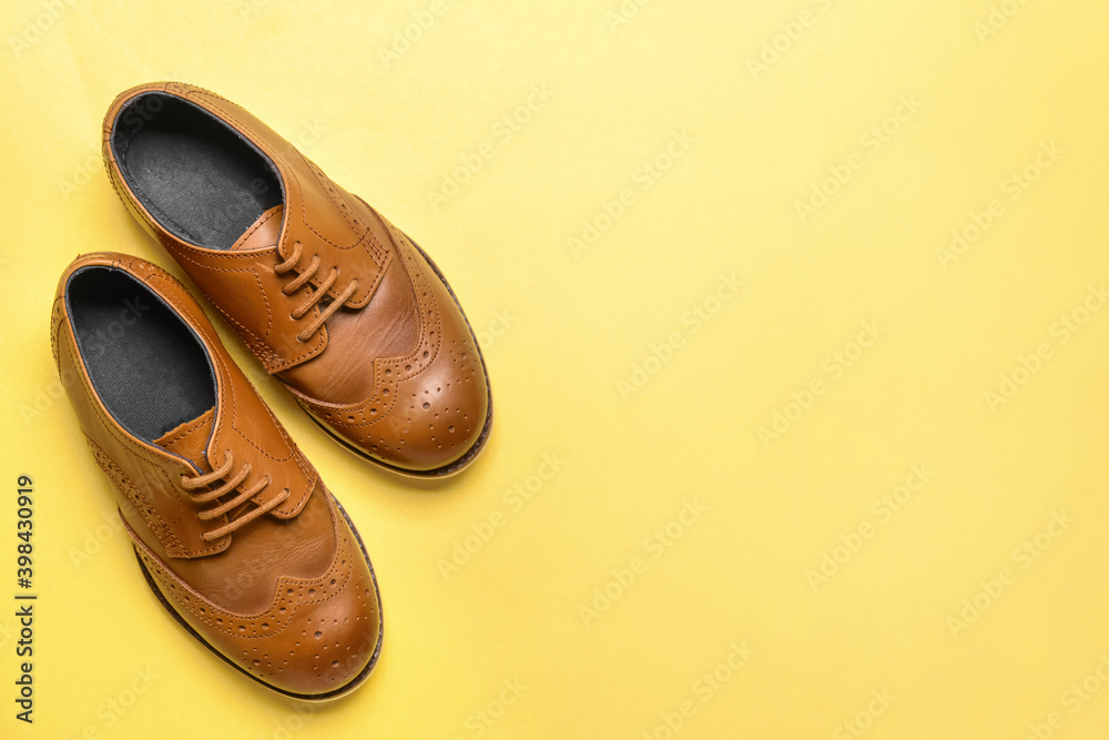 Little boy shoes on color background