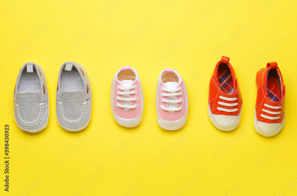 Baby shoes on color background