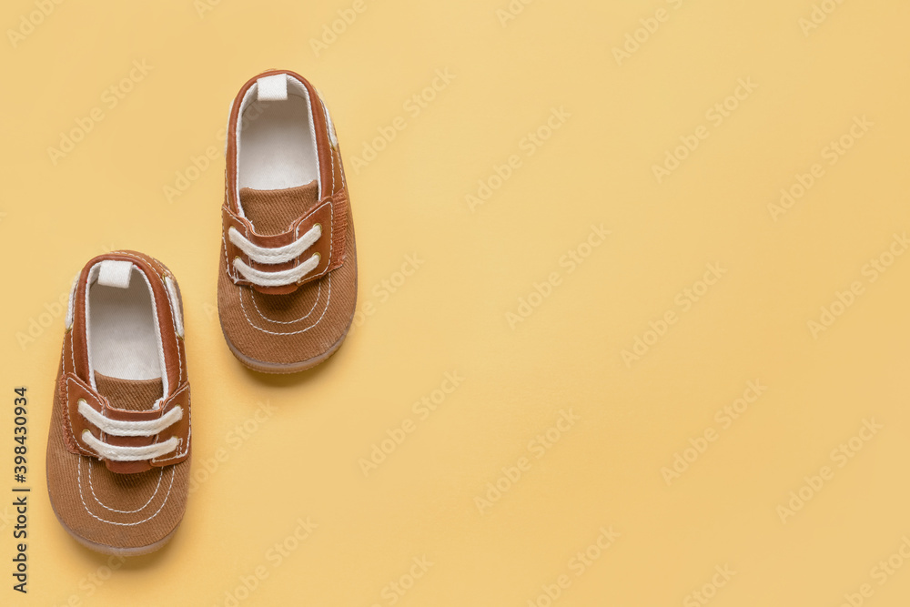 Baby shoes on color background