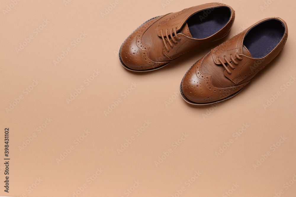 Little boy shoes on color background