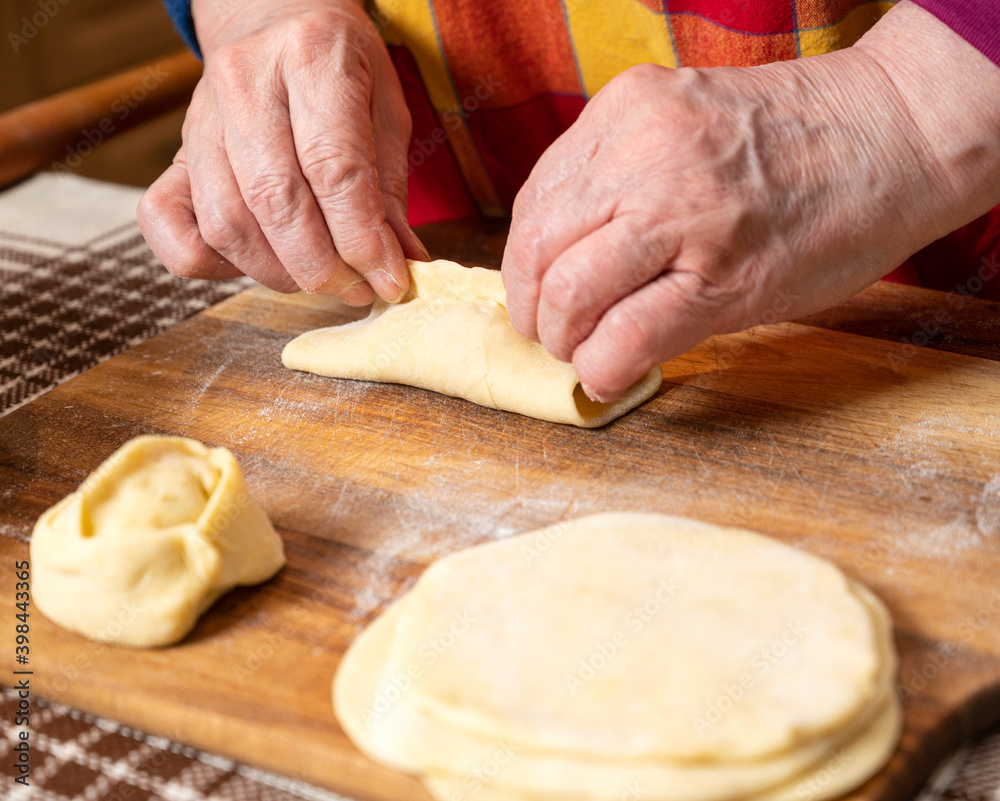  Woman making  manti  with minced beef meat