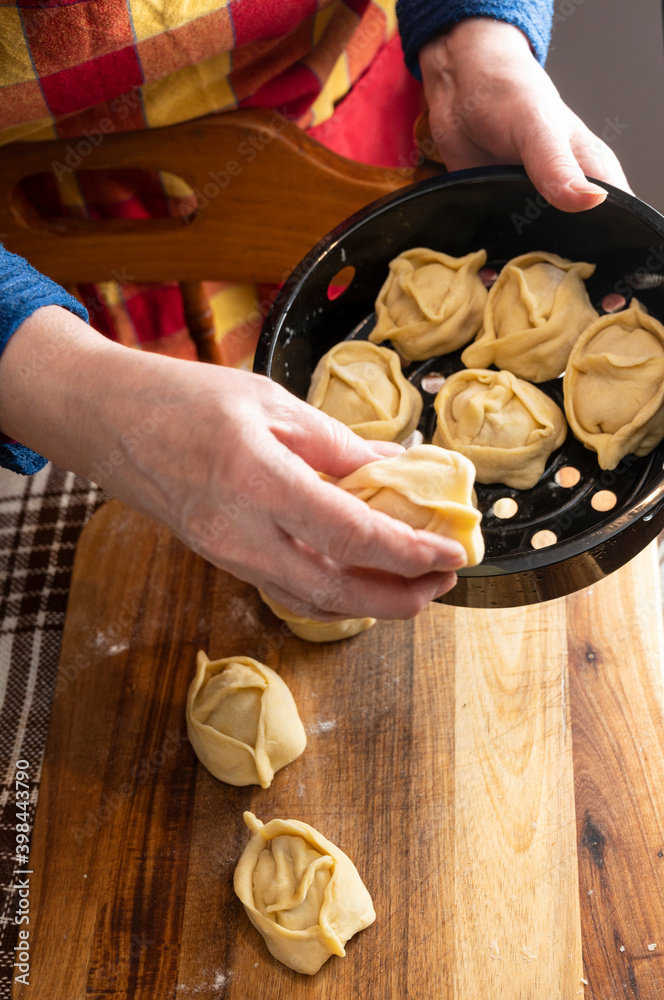  Woman making  manti  with minced beef meat