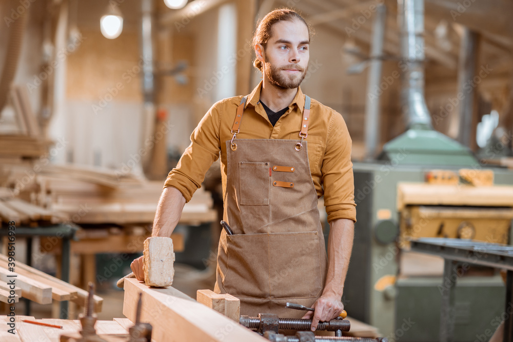 Portrait of a handsome carpenter at the joiners shop