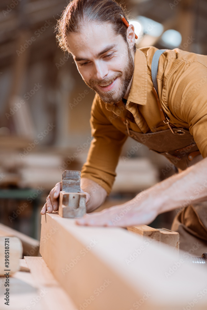 Carpenter working with a wood in the workshop