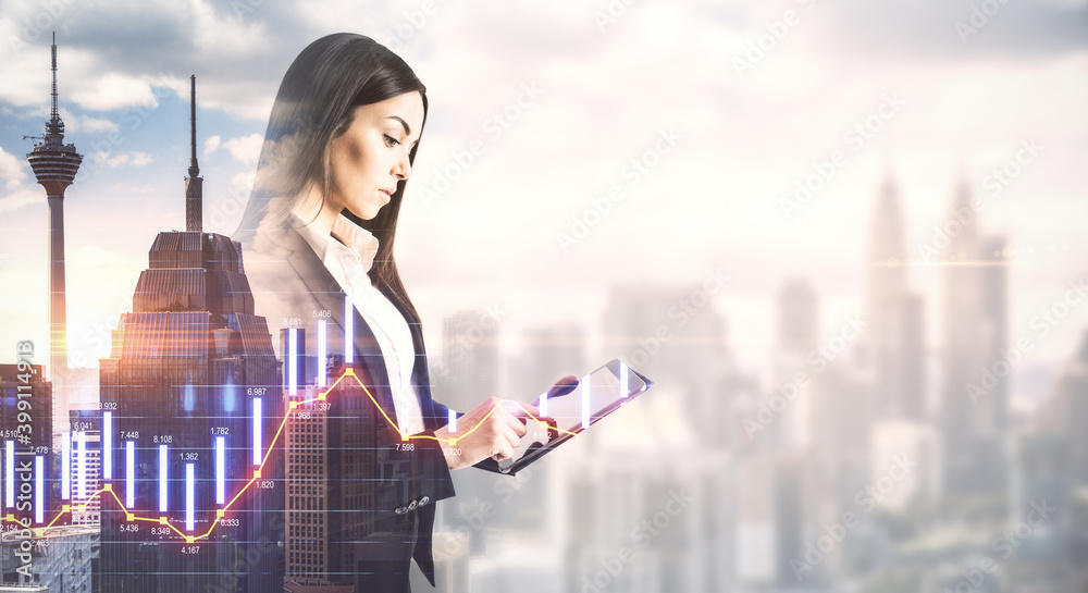 Businesswoman using digital tablet with stock chart holgram