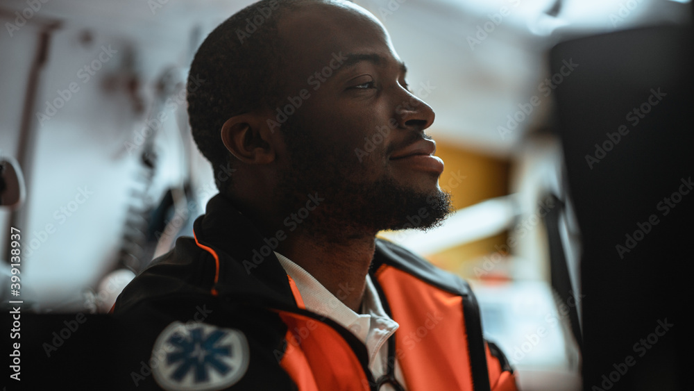 Happy Black African American Paramedic Tries to Rest in an Ambulance Vehicle Going for Emergency. Em