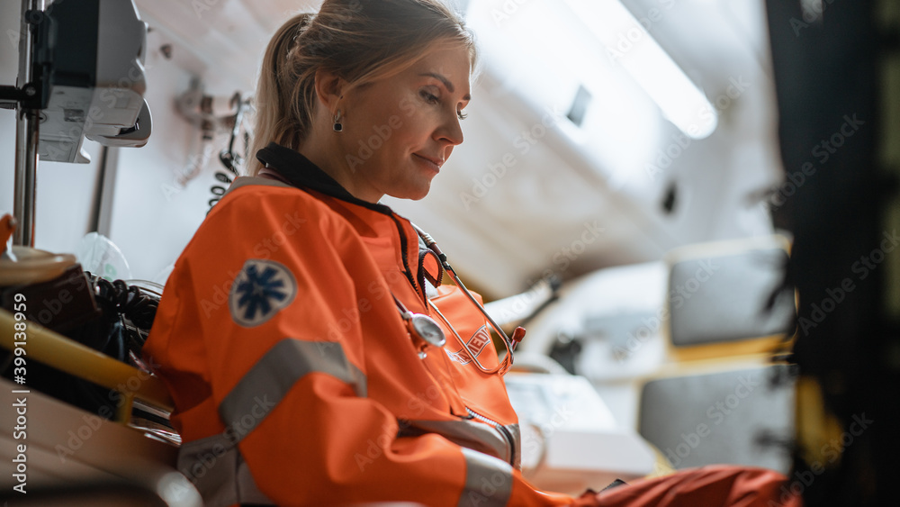 Tired Female EMS Professional Paramedic Tries to Rest in an Ambulance Vehicle on the Way to Emergenc