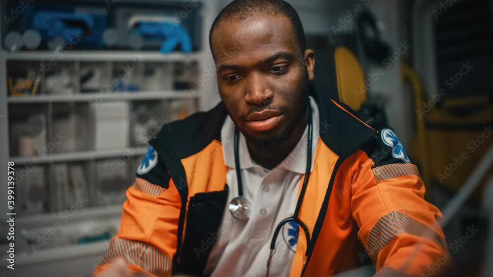 Close-up Portrait Shot of a Serious and Focused Black African American Paramedic Providews First Aid