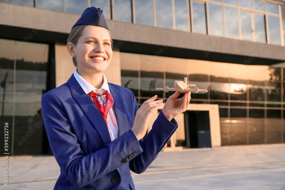 Portrait of young stewardess outdoors