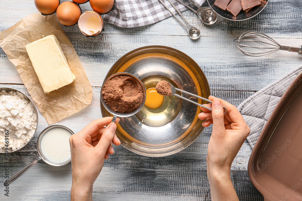 Woman preparing bakery on table, top view