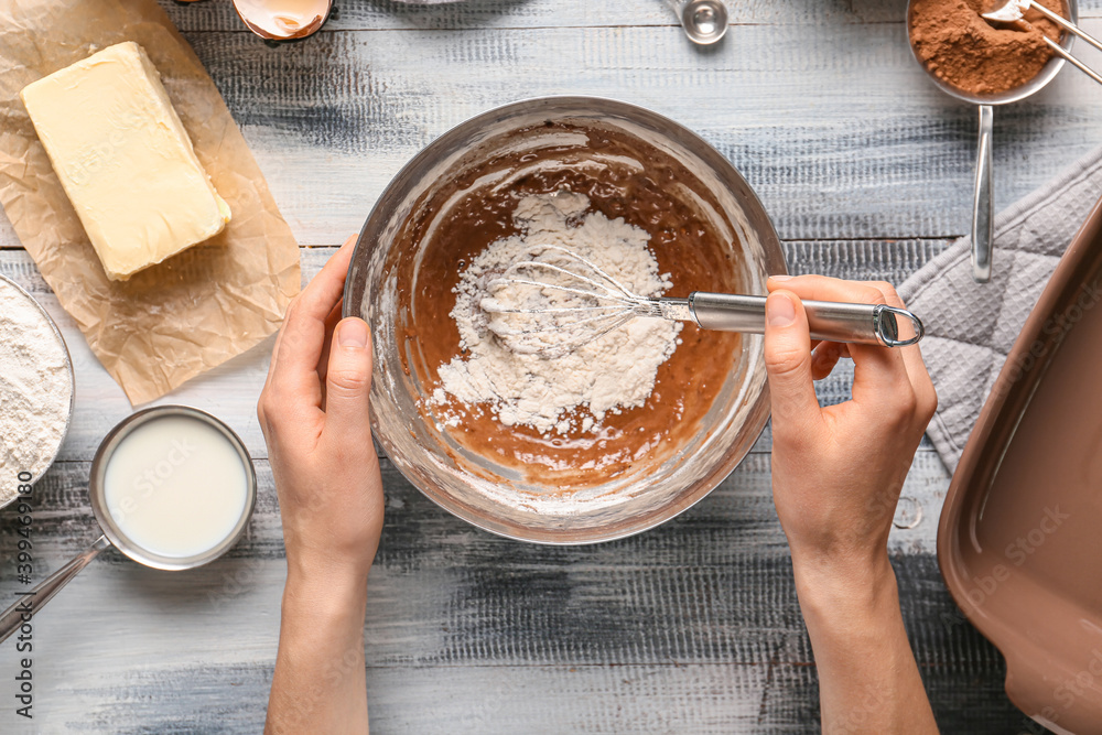 Woman preparing bakery on table, top view