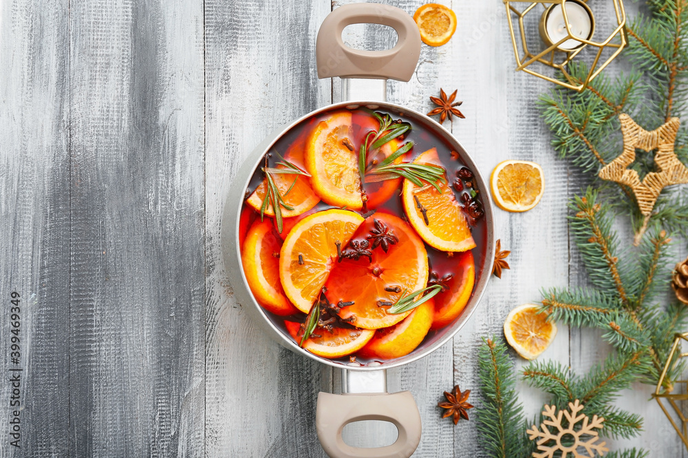 Saucepan with hot mulled wine on table